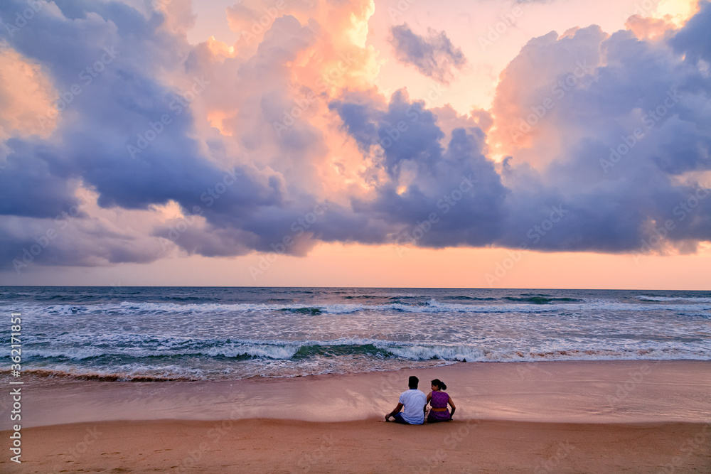 Happy Romantic Couple Enjoying Beautiful Sunset at the Beach, Goa, India