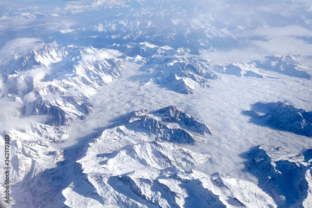 aerial view of frencj alps with snow and clouds
