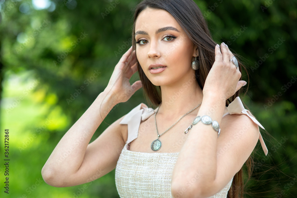 Beautiful girl with set jewelry Woman in a necklace with a ring, earrings and a bracelet. Beauty and accessories