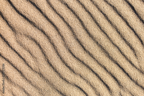Natural sand pattern, interesting abstract texture. Waves on a sand.