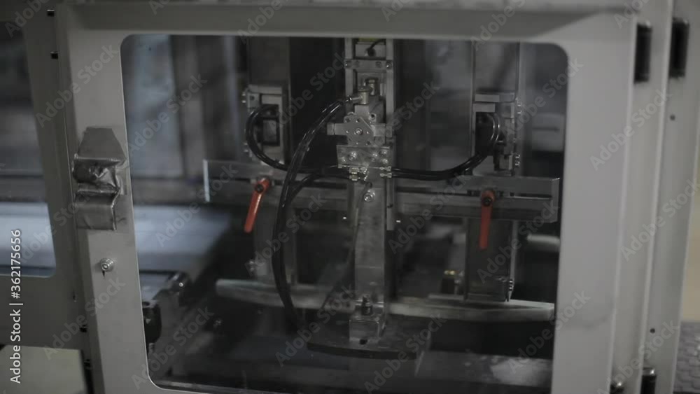 Close shot of a printing machine functioning on a factory. Close shot of a printing machine functioning on a factory.