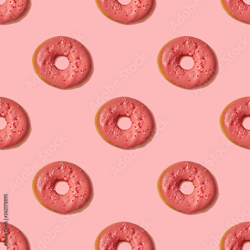 Seamless pattern of pink donuts on a pink background