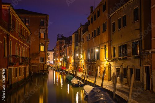 Streets and water canals of Venice at night. Night views and lights of Venice. Nightlife in Venice. Famous historical sights and places of Italy. World landmarks and historical places.