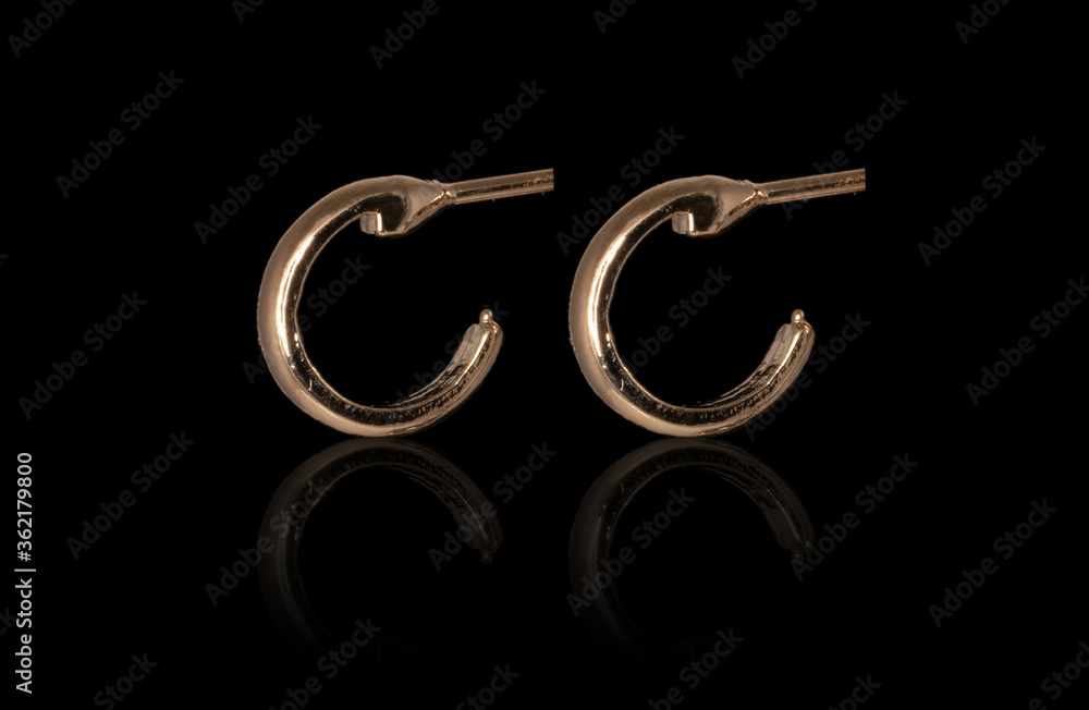 Obraz premium Golden jewelry, isolated on back, studio shot with reflection.