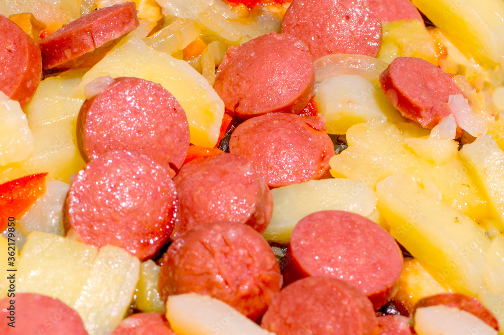 Fried potatoes and sausages with onion for breakfast Fried potatoes and sausages with onion for breakfast