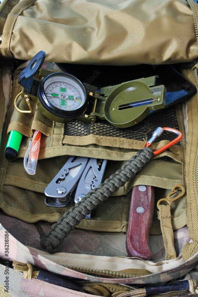 Compass, multitool and knife in a backpack Compass, multitool and knife in a backpack