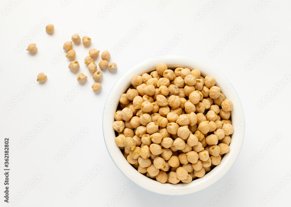 Chickpeas in a handmade ceramic bowl on grey background. Garbanzo beans traditional Near Easten food. Top view. Chickpeas in a handmade ceramic bowl on grey background. Garbanzo beans traditional Near Easten food. Top view.