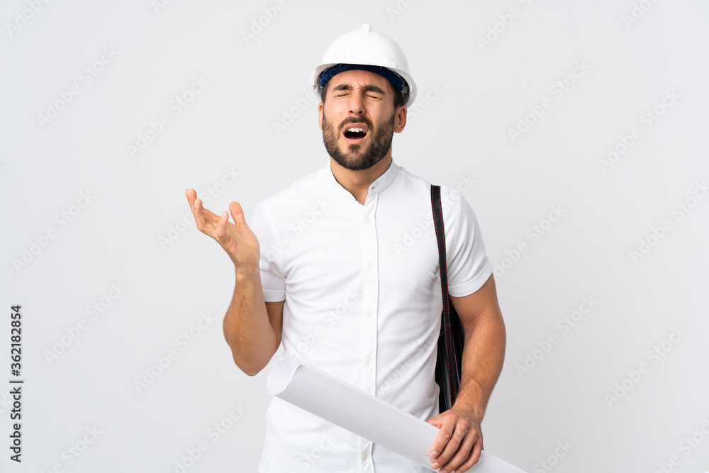 Young architect man with helmet and holding blueprints isolated on white background stressed overwhelmed Young architect man with helmet and holding blueprints isolated on white background stressed overwhelmed