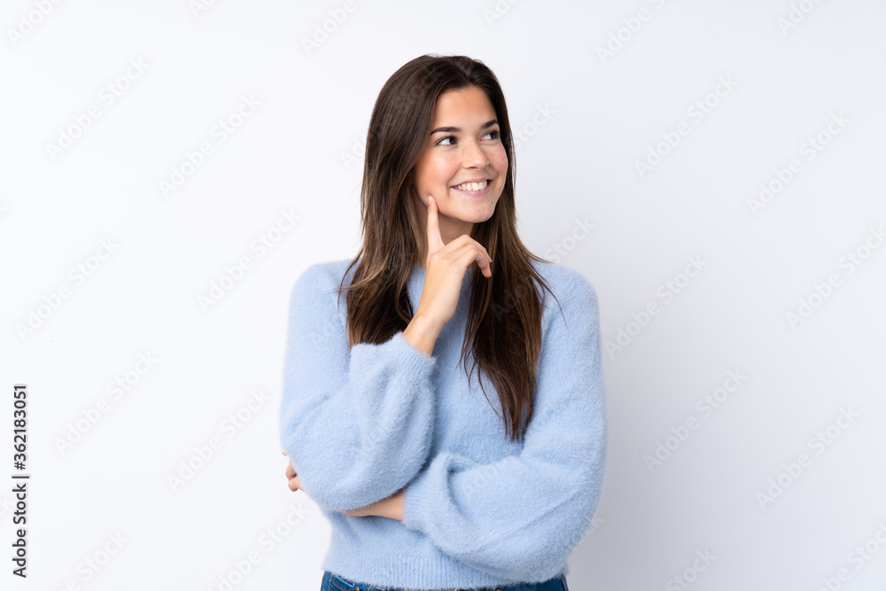 Teenager girl over isolated white background thinking an idea while looking up Teenager girl over isolated white background thinking an idea while looking up