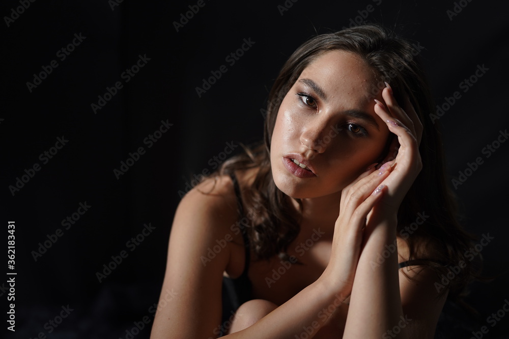 Girl in black underwear posing. Studio, looks fashionable