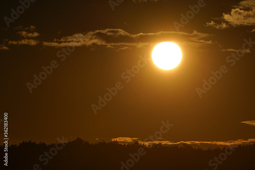 Sunset with curled clouds. the color of the sky is orange. Close up.