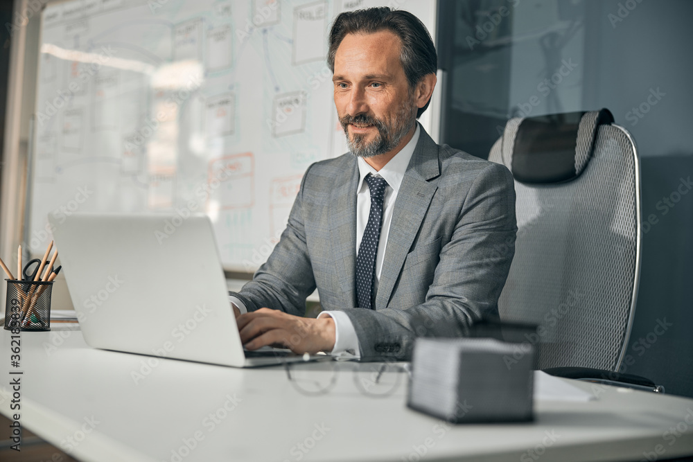 © Viacheslav Yakobchuk - European businessman wearing grey coat sitting on the office chair © Viacheslav Yakobchuk - European businessman wearing grey coat sitting on the office chair