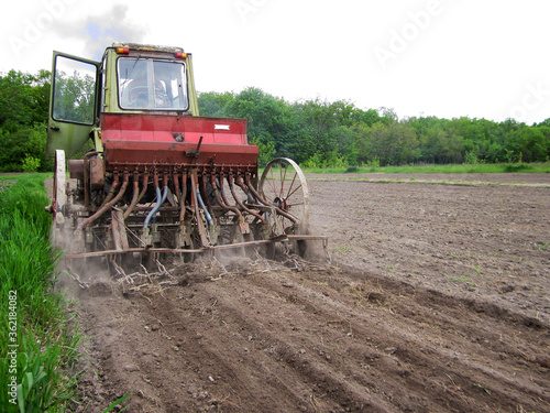 Plowed field by tractor in brown soil on open countryside nature