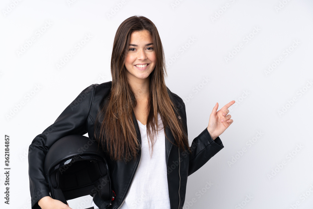 Young woman with a motorcycle helmet over isolated white background pointing finger to the side Young woman with a motorcycle helmet over isolated white background pointing finger to the side