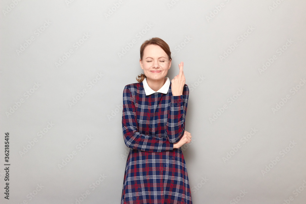 Portrait of happy girl raising crossed fingers and hoping for victory Portrait of happy girl raising crossed fingers and hoping for victory