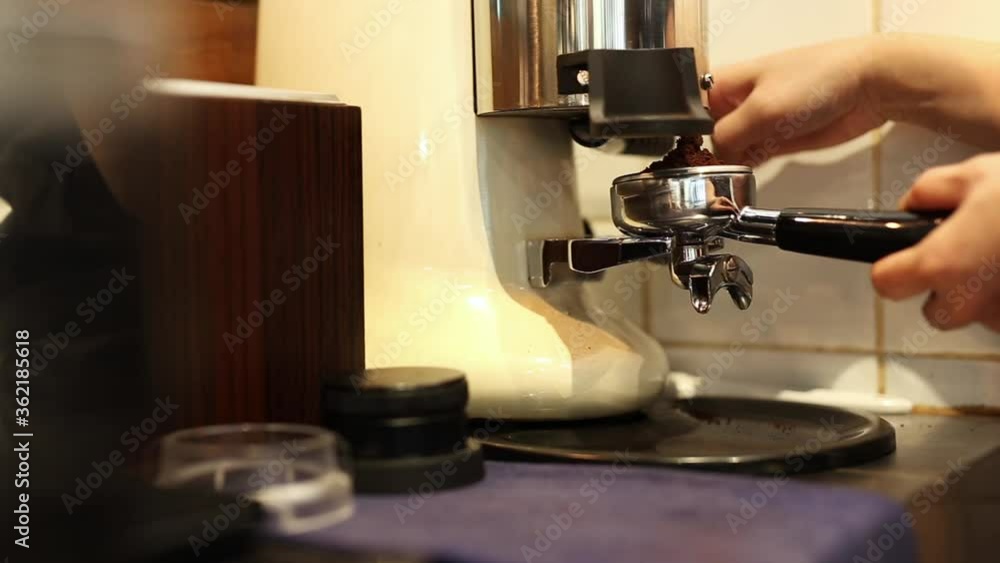 Barista put coffee ground in coffee holder. Barista put coffee ground in coffee holder.