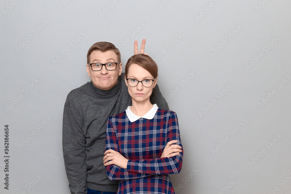 Funny weird couple, happy funny man and serious woman Funny weird couple, happy funny man and serious woman