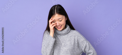 Young asian woman over isolated background laughing © luismolinero