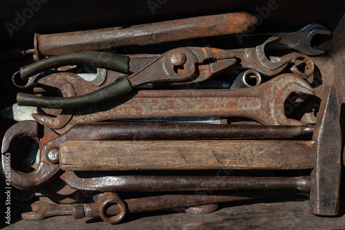  set of old rusty construction tools in a rusty old box