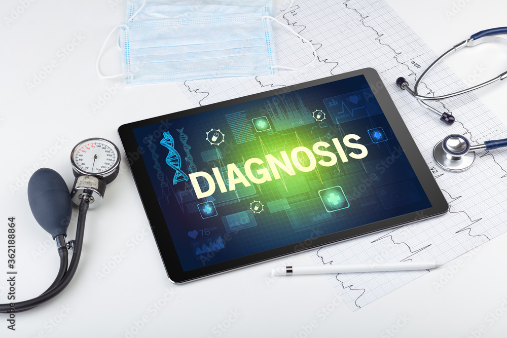Tablet pc and medical stuff with DIAGNOSIS inscription, prevention concept Tablet pc and medical stuff with DIAGNOSIS inscription, prevention concept