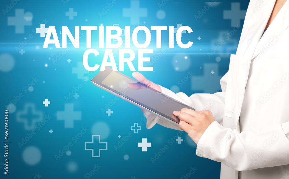 doctor writes notes on the clipboard with ANTIBIOTIC CARE inscription, first aid concept doctor writes notes on the clipboard with ANTIBIOTIC CARE inscription, first aid concept