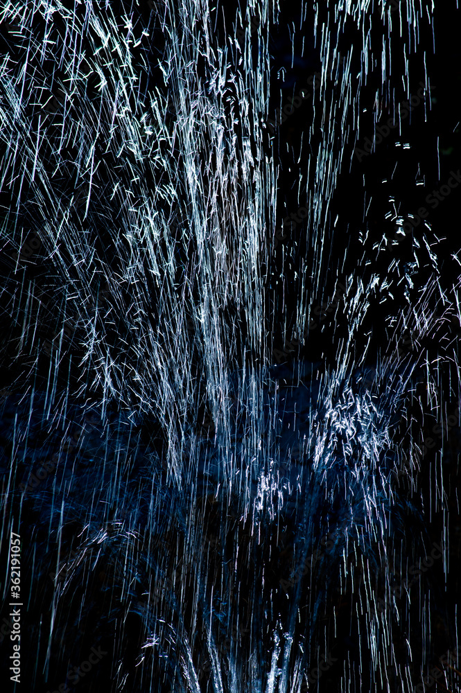 Water drops raising and falling over a black background Water drops raising and falling over a black background