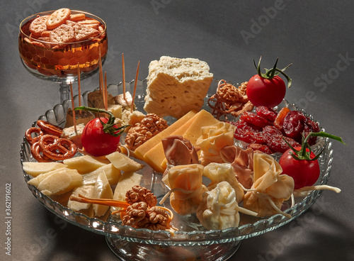 Big glass platter with different type of cheese