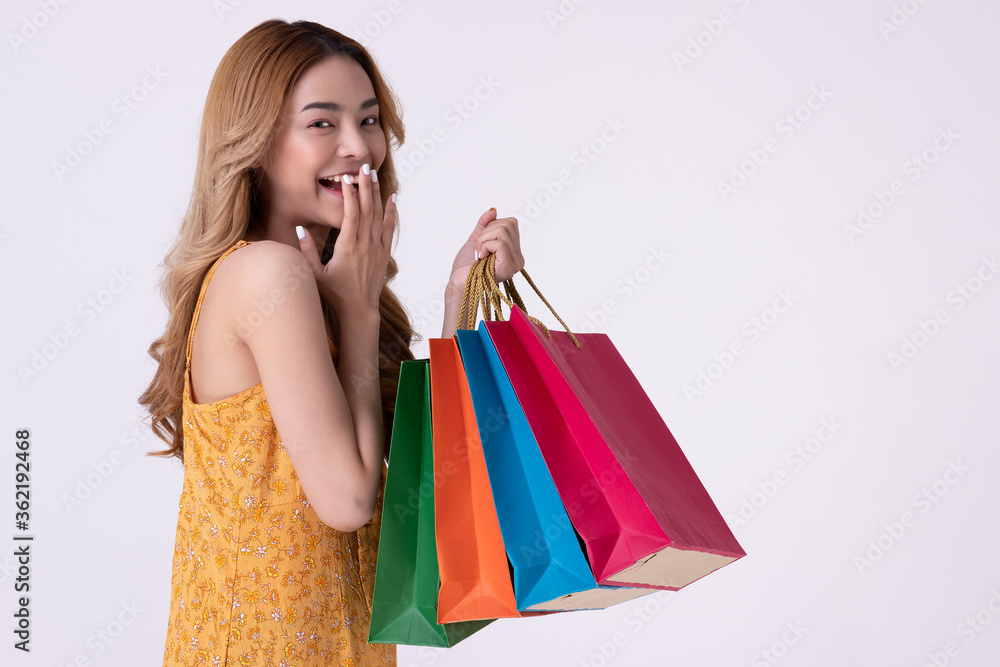 Happy asian woman holding shopping bag with mid year sale.