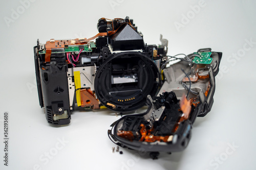 Taking apart and repairing digital camera. Close up image of camera parts.