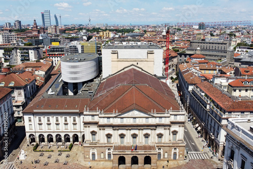 Italy , Milan July 2020 - Drone panoramic aerial view of Scala Theater after finish of lockdown due COVID19 Coronavirus outbreak,  Piazza Della Scala and new skyline and skyscrapers in downtown photo