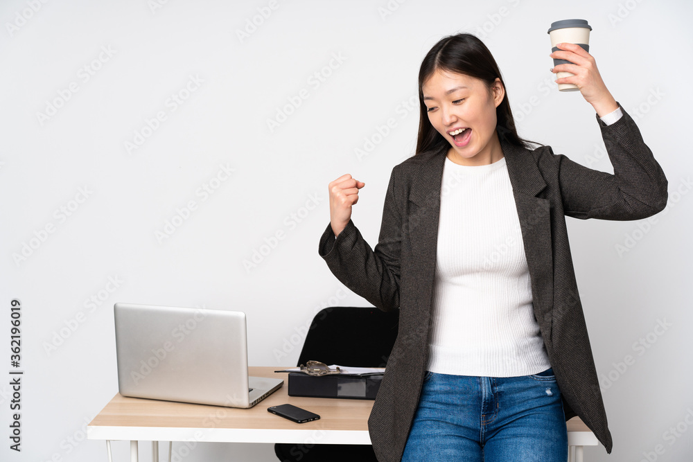 Business asian woman in her workplace isolated on white background celebrating a victory Business asian woman in her workplace isolated on white background celebrating a victory