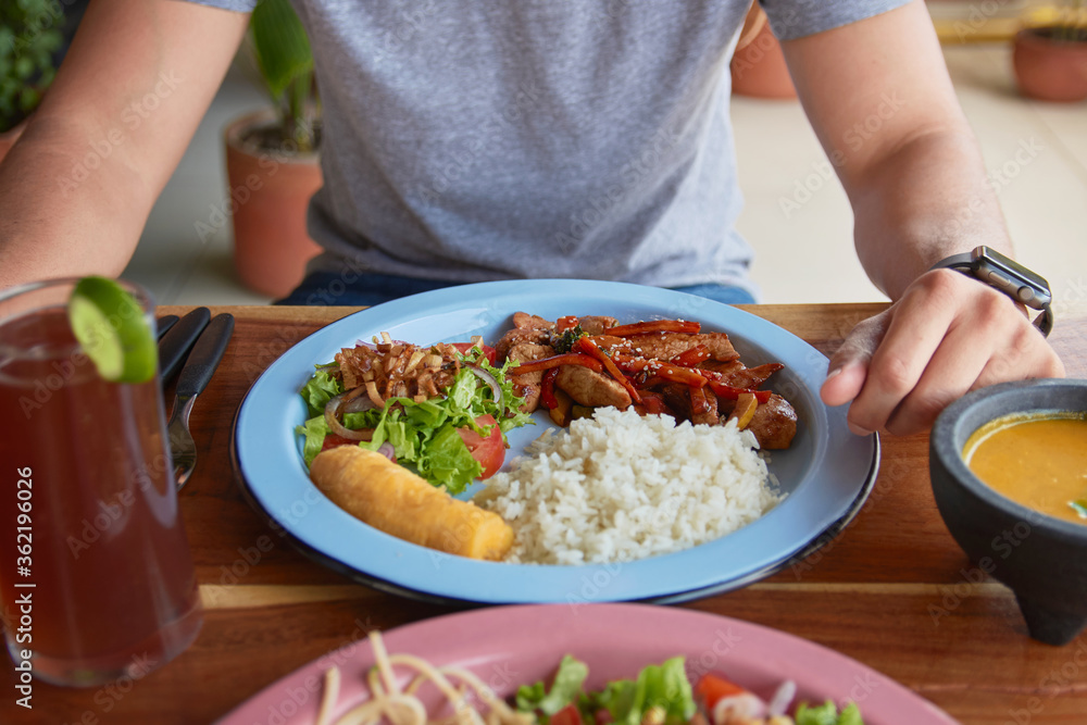 a young man waiting for lunch beef steak with vegetables a young man waiting for lunch beef steak with vegetables