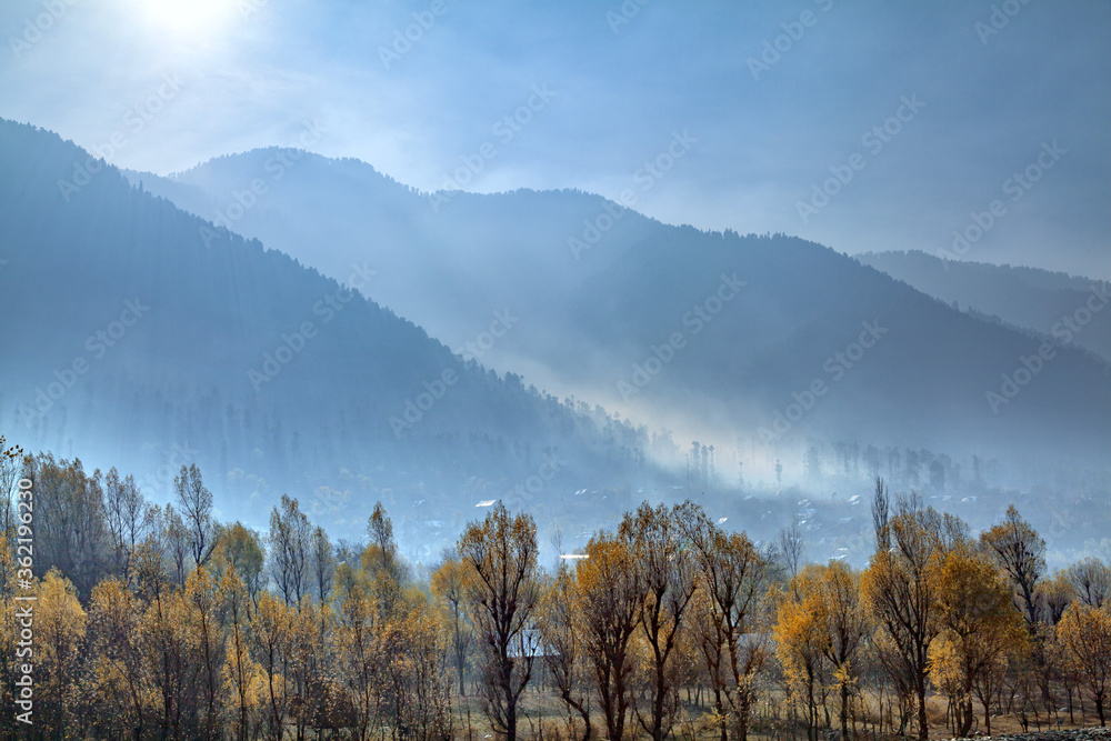 Fog covers a village at the foothills of Himalayan Mountains nea