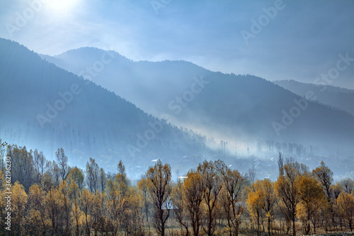 Fog covers a village at the foothills of Himalayan Mountains nea