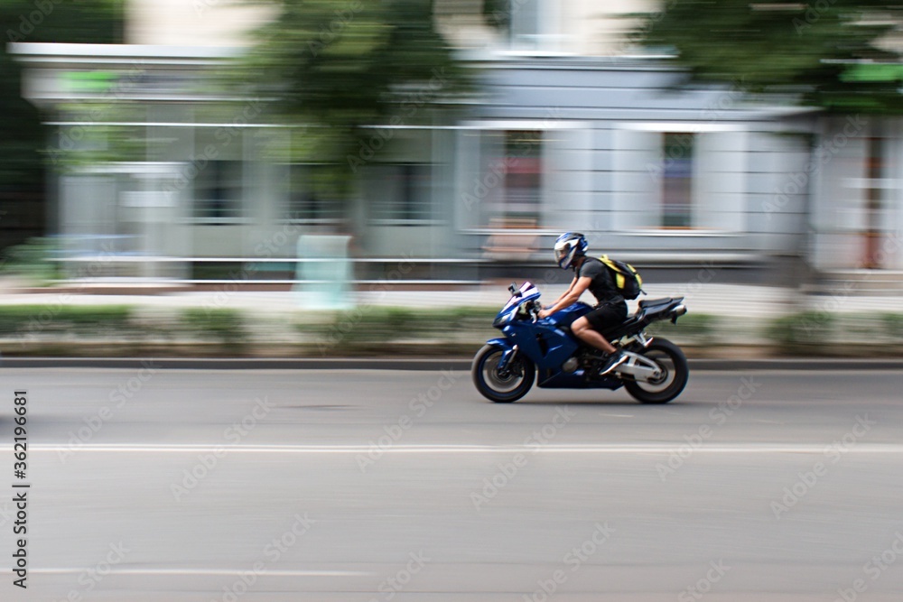 motorbiker on the city street in motion blur