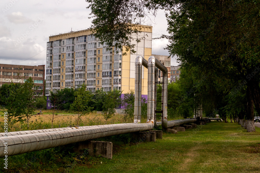 a heat pipe that runs above ground in the city,next to buildings