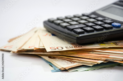 Stack with euro banknotes and a calculator. Close-up. Financial concept. Savings concept
