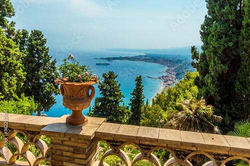 A view from a balcony in the Garden of Villa Comunale over the shoreline of Taormina, Sicily in summer