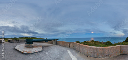 Panoramic Image of Noirmont from German Gun Emplacement taken in the evening with St Helier distance and Noirmont light house and full moon. Jersey  Channel Islands