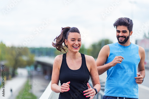 Smiling couple running on the bridge