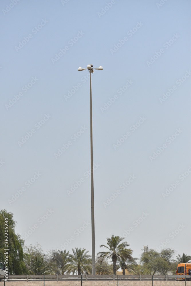 Street light isolated on blue sky background. Outdoor Lamp post in flat style.