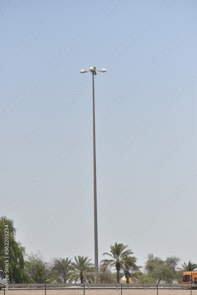 Street light isolated on blue sky background. Outdoor Lamp post in flat style. Street light isolated on blue sky background. Outdoor Lamp post in flat style.