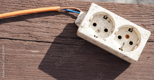 Damaged extension cable. Broken white extension cable and orange cable.