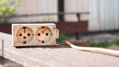 Damaged extension cable. Broken white extension cable and orange cable.