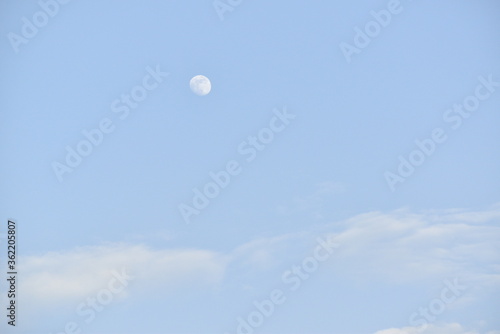 Moon and cloud on blue sky.