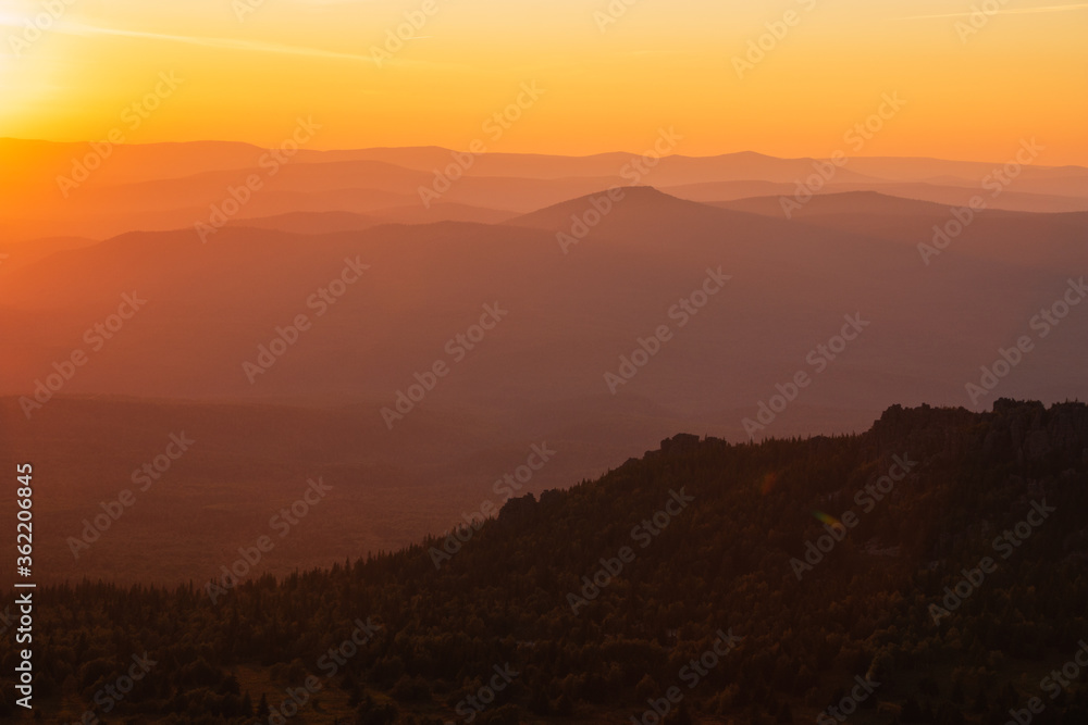 warm golden sunset over pink hills