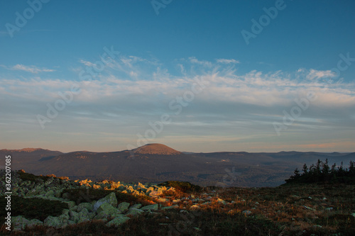 landscape with a small hill in the distance against the blue sky