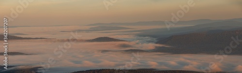 Fototapeta Naklejka Na Ścianę i Meble -  fog over the forest mountains at dusk
