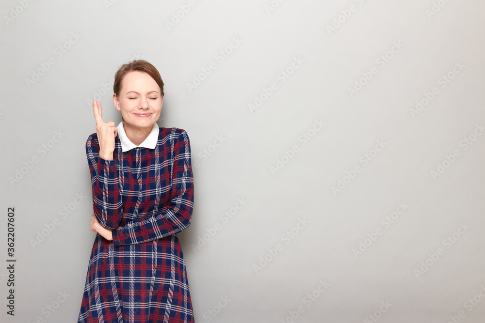 Portrait of happy girl raising crossed fingers and hoping for victory Portrait of happy girl raising crossed fingers and hoping for victory