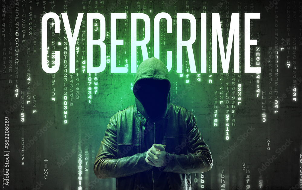 Faceless hacker with CYBERCRIME inscription, hacking concept Faceless hacker with CYBERCRIME inscription, hacking concept